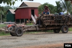 Villagers in Kampong Thom province’s Santuk district’s Kraya commune, use a two-wheeled tractor to transport forestry products they collect from nearby forests. (Sun Narin/VOA)