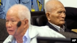 In this photo released by the Extraordinary Chambers in the Courts of Cambodia, Khieu Samphan, left, former Khmer Rouge head of state, and Nuon Chea, right, who was the Khmer Rouge's chief ideologist and No. 2 leader, sit in the court hall before they made closing statements at the U.N.-backed war crimes tribunal in Phnom Penh, file photo. 