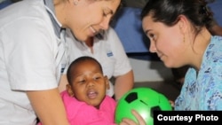 Laura Grobicki (left) and Stephanie Benn give therapy to a patient with cerebral palsy at Zithulele Hospital in South Africa ( Photo D.Taylor) 