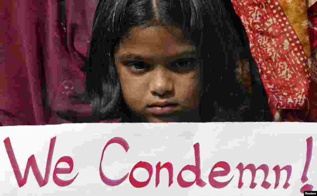 A girl holds a placard as she takes part in a protest rally in the southern Indian city of Hyderabad, December 29, 2012. 