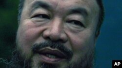 Dissident Chinese artist Ai Weiwei speaks to members of the media in the doorway of his studio after he was released on bail in Beijing, June 23, 2011.