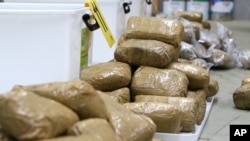 FILE - Packages containing methamphetamine are stacked in a warehouse in Melbourne.