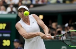 Romania's Simona Halep returns the ball to United States' Serena Williams during the women's singles final match on day twelve of the Wimbledon Tennis Championships in London, Saturday, July 13, 2019. Halep won the championship.(AP Photo/Ben Curtis)