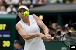 Romania's Simona Halep returns the ball to United States' Serena Williams during the women's singles final match on day twelve of the Wimbledon Tennis Championships in London, Saturday, July 13, 2019. Halep won the championship.(AP Photo/Ben Curtis)