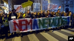 FILE - Demonstrators march through the streets of Budapest, as they protest against an internet tax planned to be introduced by the Hungarian government, for the second time in two days, in Budapest, Hungary, Oct. 28, 2014.