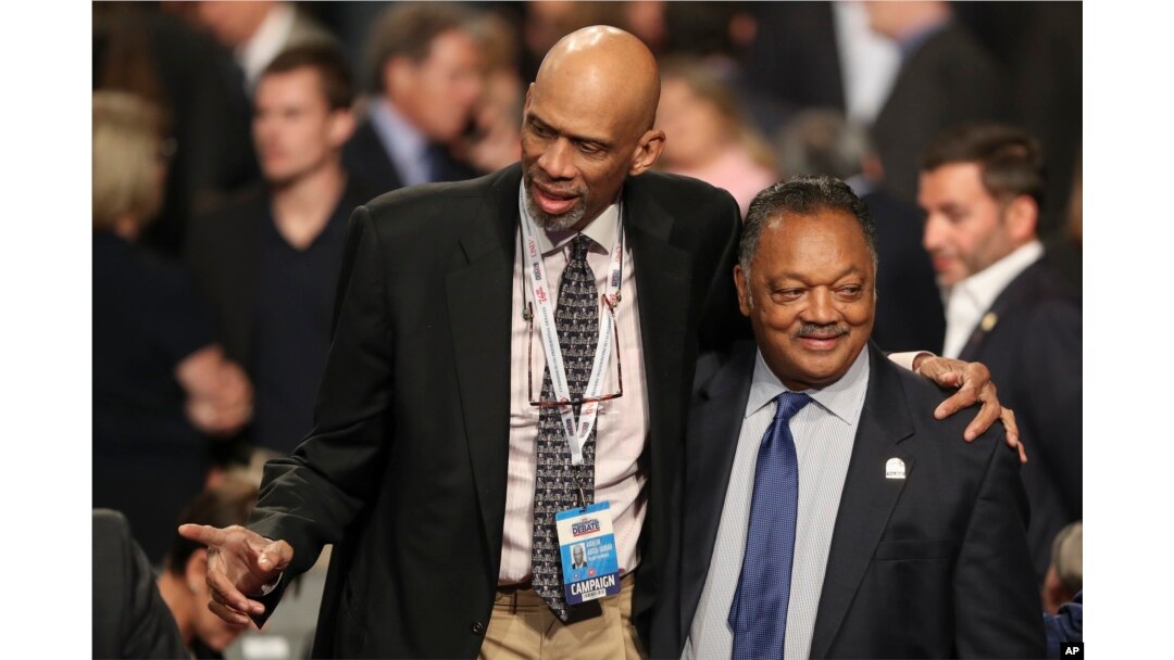 FILE - Former NBA basketball player Kareem Abdul-Jabbar stands with Jesse Jackson, Jr., before the third presidential debate at UNLV in Las Vegas, Oct. 19, 2016.