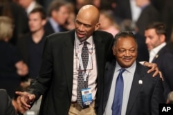 FILE - Former NBA basketball player Kareem Abdul-Jabbar stands with Jesse Jackson, Jr., before the third presidential debate at UNLV in Las Vegas, Oct. 19, 2016.