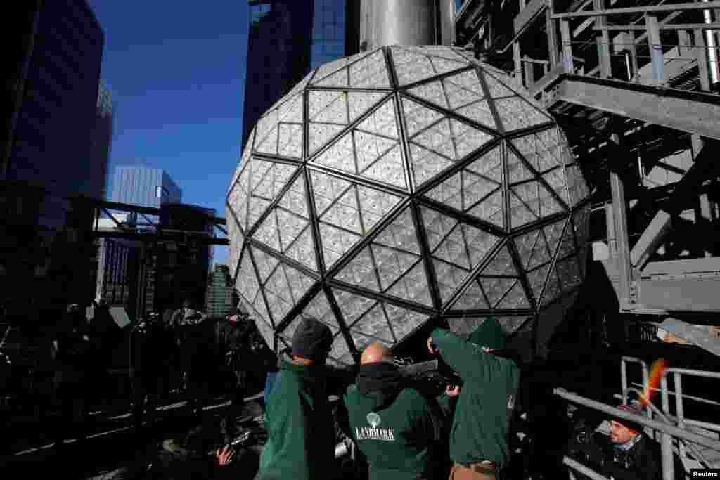 Workers install Waterford Crystal triangles on the Times Square New Year's Eve Ball on the roof of One Times Square in Manhattan, New York, U.S.