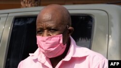 "Hotel Rwanda" hero Paul Rusesabagina in the pink inmate's uniform arrives from the Nyarugenge prison with Rwanda Correctional Service (RCS) officers at the Nyarugenge Court of Justice in Kigali, Rwanda, on September 25, 2020. - Paul Rusesabagina, whose a