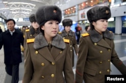 Members of the Moranbong Band of North Korea arrive at Beijing International Airport before departing from Beijing, China, Dec. 12, 2015.