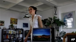Yoani Sanchez, who writes the "Generation Y" blog, walks inside her home in Havana. (file)