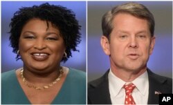 FILE - This combination of May 20, 2018, photos shows Georgia gubernatorial candidates Stacey Abrams, left, and Brian Kemp in Atlanta, Georgia. Abrams filed a federal lawsuit Sunday asking a judge to delay vote certifications in Georgia.