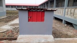 FILE- In this Thursday, Dec. 19, 2019 file photo, a newly constructed garbage bin stands by residential houses on Bhasan Char, or floating island, in the Bay of Bengal, Bangladesh.