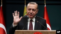 Turkey's President Recep Tayyip Erdogan gestures during a joint press conference with Venezuela's President Nicolas Maduro, following their meeting at the Presidential Palace in Ankara, Turkey, Oct. 6, 2017.