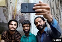 People take selfie with Rozi Khan, 26, a waiter and a lookalike of Hollywood's actor Peter Dinklage, who plays a character of Tyrion Lannister in the tv series "Game of Thrones," in Rawalpindi, Pakistan, April 28, 2019.