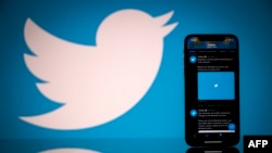 In this file photo taken on October 26, 2020 this photograph shows the logo of US social network Twitter displayed on the screen of a smartphone and a tablet in Toulouse, southern France. (AFP)