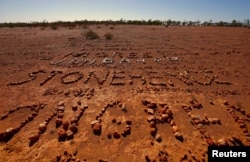Stones arranged by tourists lie on the ground, spelling out their names and the places they are from, in the area known as "The Address Book," located on the outskirts of the outback town of Stonehenge in Queensland, Australia, Aug. 12, 2017.