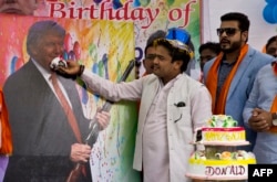 Members of the Hindu nationalist party 'Hindu Sena' or Hindu Army, celebrate the birthday of U.S. presidential candidate Donald Trump in New Delhi, India, Tuesday, June 14, 2016.