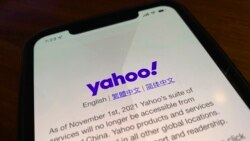 A smart phone shows the home page of Yahoo when accessed inside China in Beijing, China, Tuesday, Nov. 2, 2021. (AP Photo/Ng Han Guan)
