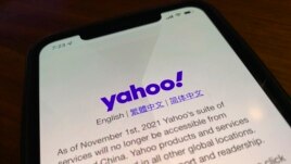 A smart phone shows the home page of Yahoo when accessed inside China in Beijing, China, Tuesday, Nov. 2, 2021. (AP Photo/Ng Han Guan)