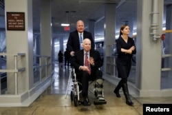 FILE - Sen. John McCain heads to the Senate floor ahead of votes on Capitol Hill in Washington, Dec. 6, 2017.