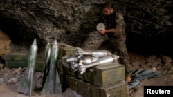 A Free Syrian Army fighter prepares ammunition inside a cave in Maaret al-Naaman village, in Idlib, Syria, Oct. 17, 2013.