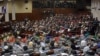 FILE - Afghan parliament members listen to a speech by President Ashraf Ghani as he inaugurates a new session of parliament at the parliament house in Kabul, Afghanistan, March, 7, 2015. 