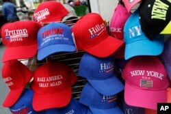 Hats displaying support for Democrat Hillary Clinton and her opponent Republican presidential candidate Donald Trump are displayed by a sidewalk vendor in New York, Aug. 16, 2016.