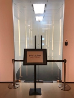 A sign that reads "door closed" is pictured at the exit of PageGroup's office after reopening, as the coronavirus disease (COVID-19) continues, in Shanghai, China, April 29, 2020.