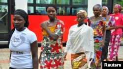FILE - Girls who escaped from their Boko Haram captors arrive at the presidential villa in Abuja, July 22, 2014. 