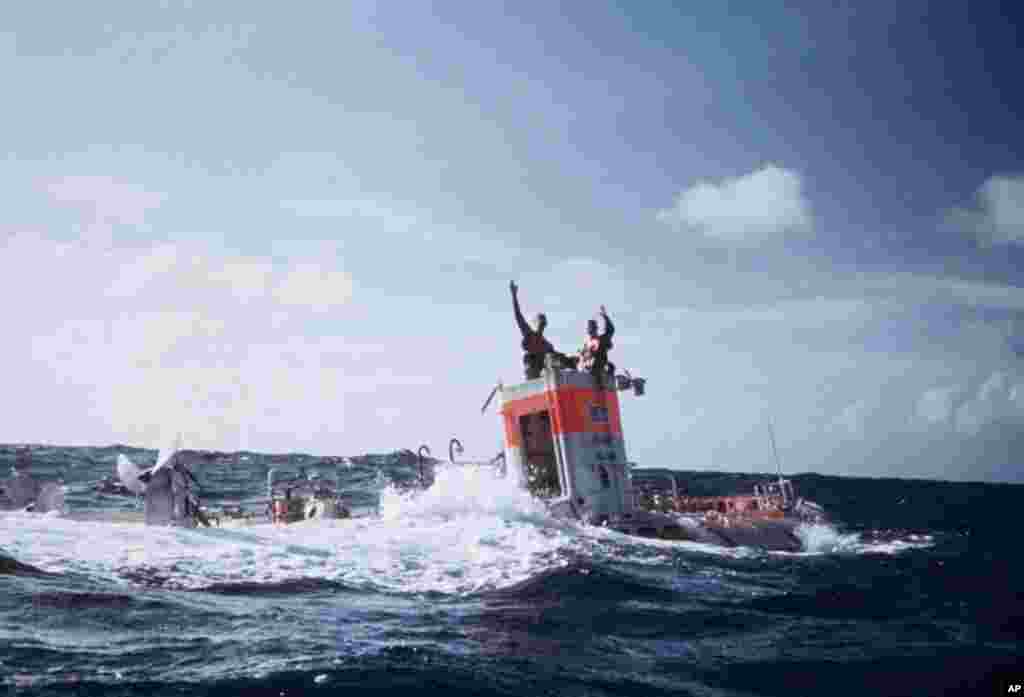 Jacques Piccard and Don Walsh emerge from the bathyscaphe Trieste following their successful manned descent to the bottom of the Mariana Trench in January 1960. (Photo: Thomas J. Abercrombie)