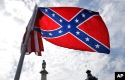 A protester waves a Confederate battle flag in front of the South Carolina statehouse, July 9, 2015, in Columbia, South Carolina.