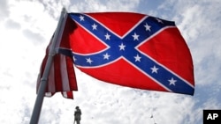 A protester waves a Confederate battle flag in front of the South Carolina statehouse, July 9, 2015, in Columbia, South Carolina.