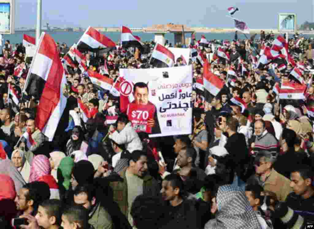 Thousands of Egyptian anti-government protesters march Alexandria, Egypt, Friday, Feb. 11, 2011. Egypt's military threw its weight Friday behind President Hosni Mubarak's plan to stay in office through September elections while protesters fanned out to th