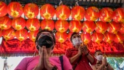 People pray for good fortune on the eve of the Lunar New Year at Tai Hong Kong Shrine in Bangkok, Thailand, Monday, Jan. 31, 2022. (AP Photo/Sakchai Lalit)