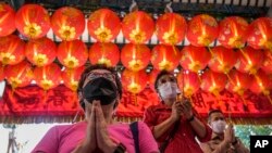 People pray for good fortune on the eve of the Lunar New Year at Tai Hong Kong Shrine in Bangkok, Thailand, Monday, Jan. 31, 2022. (AP Photo/Sakchai Lalit)