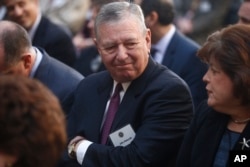FILE - Former Bush administration Attorney General John Ashcroft is seated before President Barack Obama and FBI Director James Comey arrive at an installation ceremony at FBI Headquarters in Washington, Oct. 28, 2013.