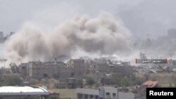 Video uploaded by the Syrian Army on May 13, 2017 shows smoke rising from Qaboun, on the edge of the capital Damascus, Syria. 