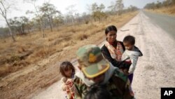 A Cambodian family is seen on an empty road as they flee the area near the 11th-century Preah Vihear temple on the border between Thailand and Cambodia, February 7, 2011.