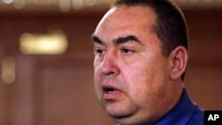 FILE - Igor Plotnitsky speaks to reporters after talks about a cease-fire in Ukraine in Minsk, Belarus, Sept. 5, 2014. Plotnitsky, the Kremlin-installed leader of the Russian-occupied part of Ukraine's Luhansk Oblast, resigned Nov. 24, 2017, "due to health reasons," the Luhansk separatists' Security Minister Leonid Pasechnik said.