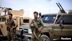 FILE - Fighters of Syrian Democratic Forces are seen in Deir el-Zour, Syria May 1, 2018.