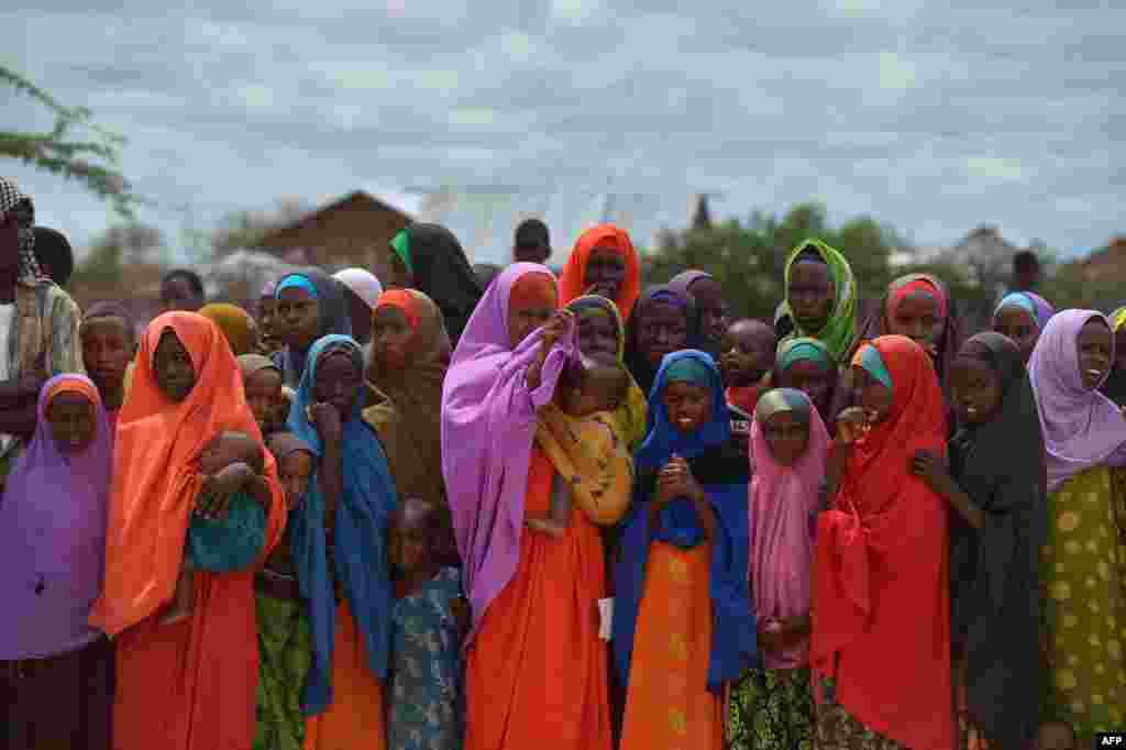 Refugees gather to watch the arrival of United Nations High Commissioner for Refugees Antonio Guterres at the sprawling Dadaab refugee camp in Kenya. The camp currently houses some 350,000 people and for more than 20 years has been home to generations of Somalis who have fled their homeland wracked by conflicts.