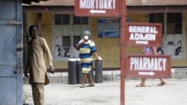 People walk inside the Yaba Mainland hospital compound where an Italian citizen who entered Nigeria on Tuesday from Milan on a business trip, the first case of the COVID-19 virus is being treated in Lagos Nigeria Friday, Feb. 28, 2020. (AP Photo)