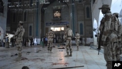 Pakistani para-military soldiers stand alert after a deadly suicide attack at the shrine of famous Sufi Lal Shahbaz Qalandar in Sehwan, Pakistan, Feb. 16, 2017.