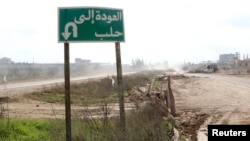 A road sign that reads 'back to Aleppo' is seen at the main north-south highway linking Aleppo with Damascus, near the Wadi al-Deif military base that the rebel fighters took control of from forces loyal to Syria's President Bashar al-Assad earlier this m
