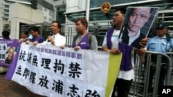 Người biểu tình ở Hồng Kông cầm ảnh Luật sư nhân quyền Phố Chí Cường, đòi Bắc Kinh phóng thích ông, ngày 14/5/2014. 