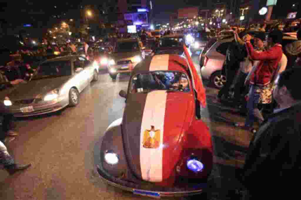 An old Volkswagen car is painted in Egyptian flag colors during celebrations after President Hosni Mubarak resigned and handed power to the military in Cairo, Egypt, Friday, Feb. 11, 2011. Egypt exploded with joy, tears, and relief after pro-democracy pr
