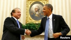 U.S. President Barack Obama shakes hands with Pakistan's Prime Minister Nawaz Sharif in the Oval Office at the White House in Washington, Oct. 23, 2013.