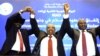 Sudanese President Omar al-Bashir, center, raises hands with South Sudan's President Salva Kiir, left, and South Sudanese rebel leader Riek Machar after the two South Sudanese arch-foes agreed in Khartoum, June 27, 2018, to a "permanent" cease-fire to take effect within 72 hours in their country.
