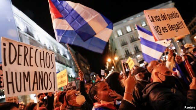 FILE - People take part in a protest to support Cuban dissidents and to demand human rights in Cuba, at Puerta del Sol square in Madrid, Spain, November 15, 2021.